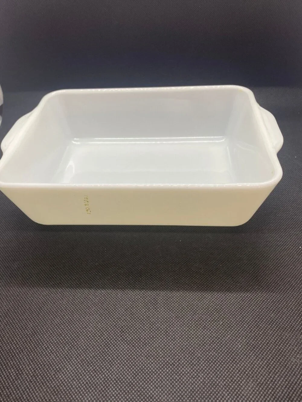 Pyrex White Casserole Dish. Only a small bit of the green design remains. 1 1/2